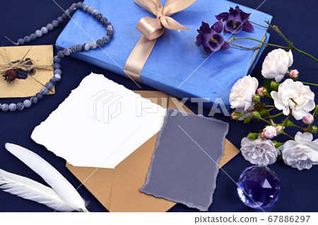 Old book with empty paper sheet, decoration, quill and roses. Mystic and romantic background with copy space and blank, vintage romantic concept for mock up, top view Old book with empty paper sheet, decoration, quill and roses. Mystic and romantic background with copy space and blank, vintage romantic concept for mock up, top view 67886297