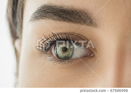 Close up of face of beautiful caucasian young woman, focus on eyes. Human emotions, facial expression, cosmetology, body and skin care concept. Close up of face of beautiful caucasian young woman, focus on eyes. Human emotions, facial expression, cosmetology, body and skin care concept. 67886998