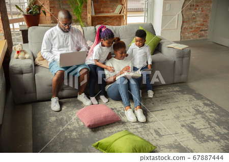 Young african family during quarantine, insulation spending time together at home 67887444