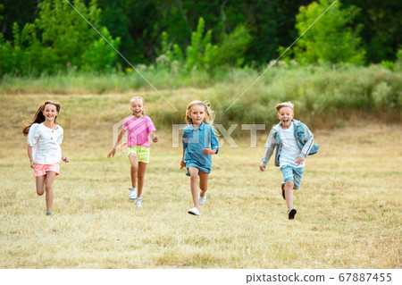 Kids, children running on meadow in summer's sunlight Kids, children running on meadow in summer's sunlight 67887455