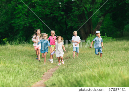Kids, children running on meadow in summer's sunlight Kids, children running on meadow in summer's sunlight 67887481