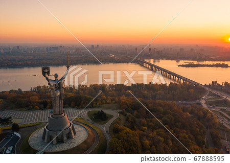 Kiev skyline over beautiful fiery sunset, Ukraine. Monument motherland. 67888595