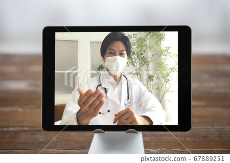 Tablet PC online with doctor using call app (subjective shot of patient) 67889251