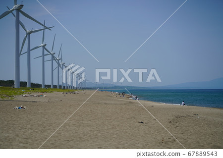Landscape of sandy beach and windmill 67889543