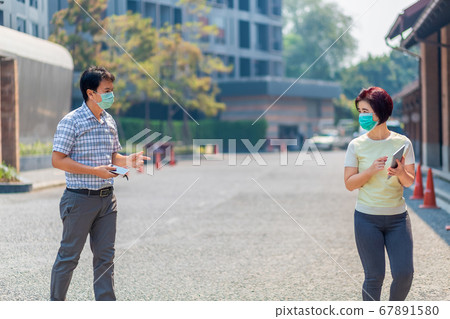 Asian middle aged people wearing mask and keep Asian middle aged people wearing mask and keep 67891580