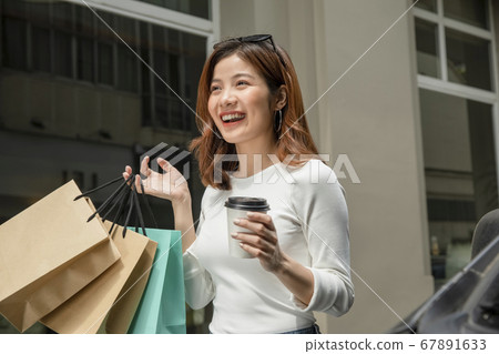 Woman walking around town 67891633