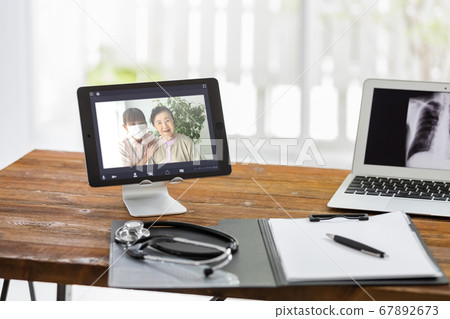 Senior woman receiving online medical treatment via video call and her care staff (doctor's subjective shot) Senior woman receiving online medical treatment via video call and her care staff (doctor's subjective shot) 67892673