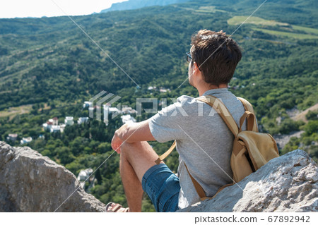 Tourist with backpack enjoy valley view from top Tourist with backpack enjoy valley view from top 67892942