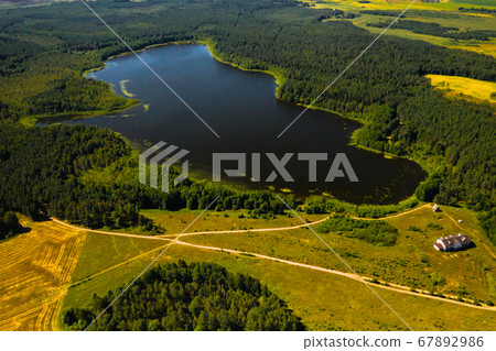 Top view of the lake Bolta in the forest in the Braslav lakes National Park, the most beautiful places in Belarus.An island in the lake.Belarus. Top view of the lake Bolta in the forest in the Braslav lakes National Park, the most beautiful places in Belarus.An island in the lake.Belarus. 67892986