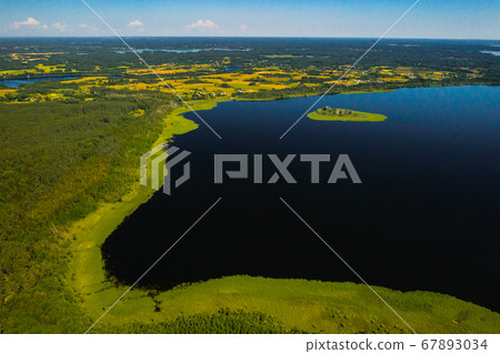 Top view of lake Drivyaty in the Braslav lakes National Park, the most beautiful lakes in Belarus.An island in the lake.Belarus. Top view of lake Drivyaty in the Braslav lakes National Park, the most beautiful lakes in Belarus.An island in the lake.Belarus. 67893034