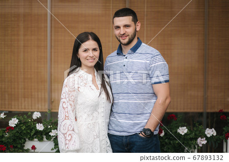 Portrait of Beautiful young woman with her husband outdoors Portrait of Beautiful young woman with her husband outdoors 67893132