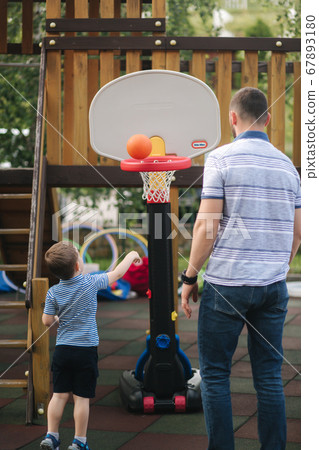 Back view of sun play with dad. Happy family 67893180