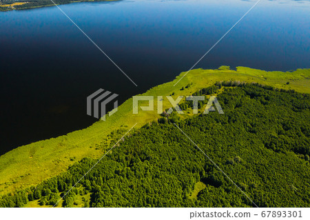 Top view of lake Drivyaty in the Braslav lakes National Park, the most beautiful lakes in Belarus.An island in the lake.Belarus. Top view of lake Drivyaty in the Braslav lakes National Park, the most beautiful lakes in Belarus.An island in the lake.Belarus. 67893301