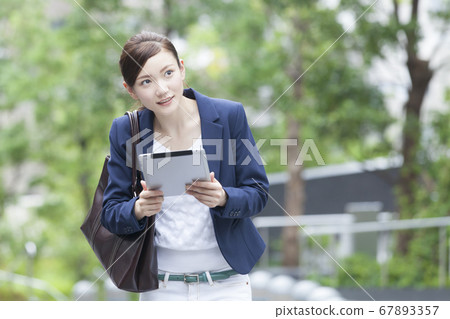 OL walking with a tablet PC OL walking with a tablet PC 67893357
