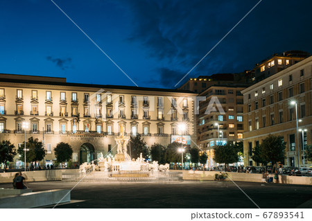 Naples, Italy. Fountain Of Neptune On Piazza Municipio In Evening Or Night Illuminations 67893541