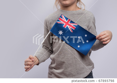 Child holds flag of Australia. Close up. Traveling Child holds flag of Australia. Close up. Traveling 67893798