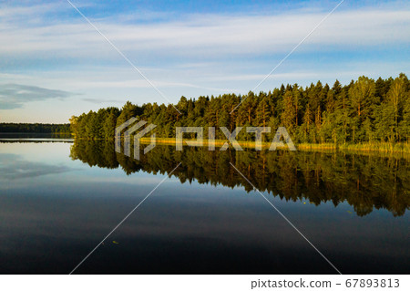 Top view of Bolta lake in the forest in the Braslav lakes National Park at dawn, the most beautiful places in Belarus.An island in the lake.Belarus. 67893813