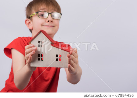 Happy boy shows model home. Real estate, family Happy boy shows model home. Real estate, family 67894456