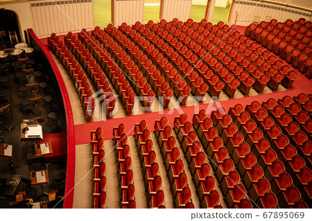 Red seats in the rows without people in Vienna State Opera auditorium. Red seats in the rows without people in Vienna State Opera auditorium. 67895069