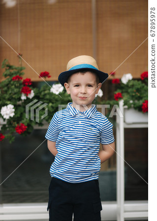 Portrait of little boy outdoor in summer time. Happy smiled kid. in straw hat Portrait of little boy outdoor in summer time. Happy smiled kid. in straw hat 67895978
