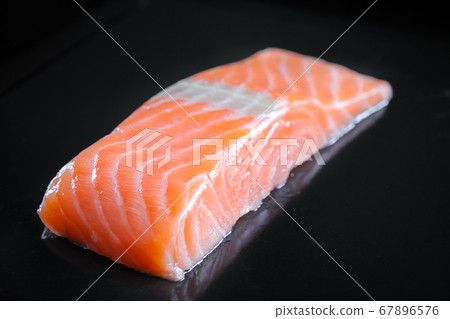Salmon steak isolated on black background Salmon steak isolated on black background 67896576