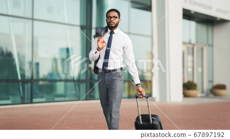 Serious Businessman Making Business Trip Walking At Airport Outdoors, Panorama 67897192