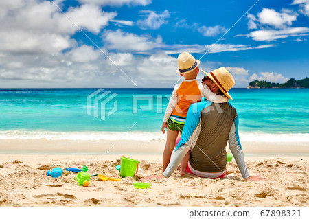 Toddler boy on beach with father 67898321