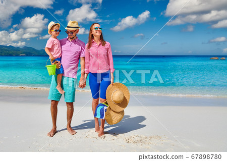 Family with three year old boy on beach. Family with three year old boy on beach. 67898780