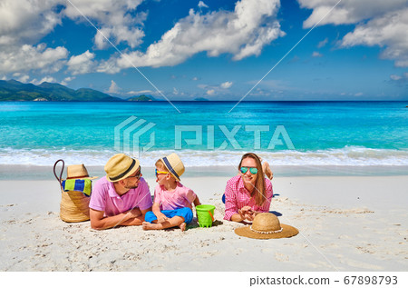 Family with three year old boy on beach. Family with three year old boy on beach. 67898793