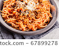 Spaghetti bolognese with mushrooms and cheese. 67899278