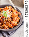 Spaghetti bolognese with mushrooms and cheese. 67899279