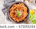 Spaghetti bolognese with mushrooms and cheese. 67899284