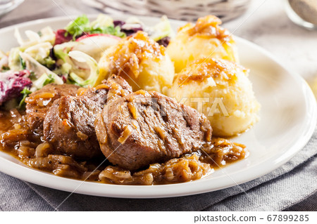 Braised pork loins with onion sauce Braised pork loins with onion sauce 67899285