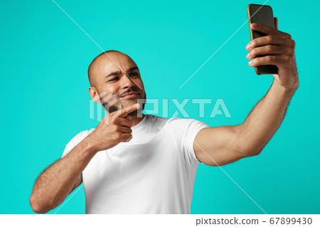 Young cheerful african american man taking selfie picture 67899430