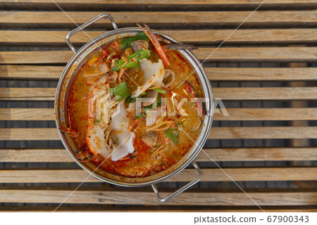 Tom Yum kung on hot pot, Spicy Sour Soup with herb and giant freshwater prawn, Thai traditional food, thailand 67900343