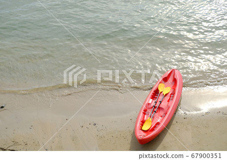 red boat on the beach, kayak on the sand and beach background 67900351