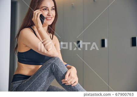 Dark-haired lady talking on the cellular phone 67900763