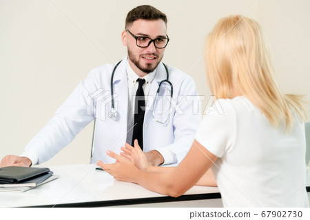 Male Doctor and Female Patient in Hospital Office Male Doctor and Female Patient in Hospital Office 67902730
