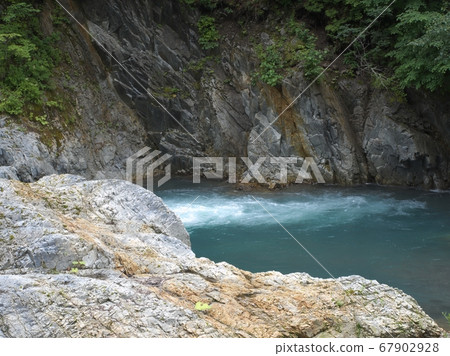 Clear current under the waterfall 67902928