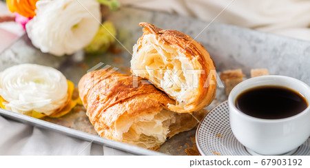 Fresh Croissant, Cup of Coffee and Ranunculus Flowers. Breakfast 67903192