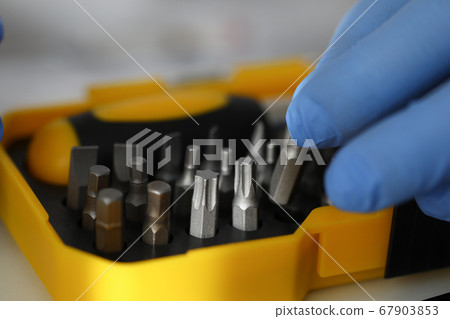 Gloved hand holds set of screwdriver bit sprocket 67903853