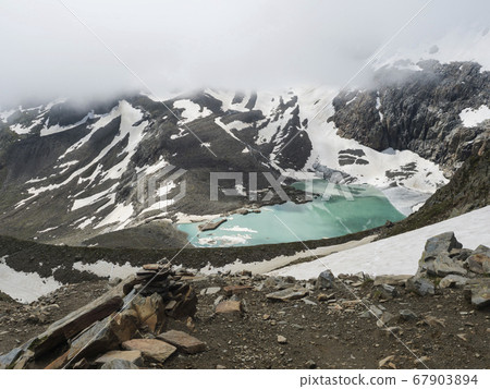 summer view of the Sulzenauferner Glacier and turquoise glacial lake and waterfall from melting ice. Stubai Alps, Austria 67903894