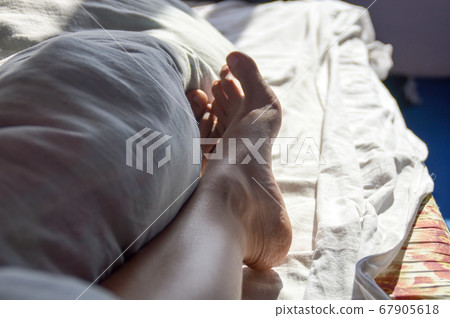 Conceptual photo showing the comfort and calm of staying in bed all day as the new normal lifestyle during home quarantine due to covid-19 pandemic 67905618
