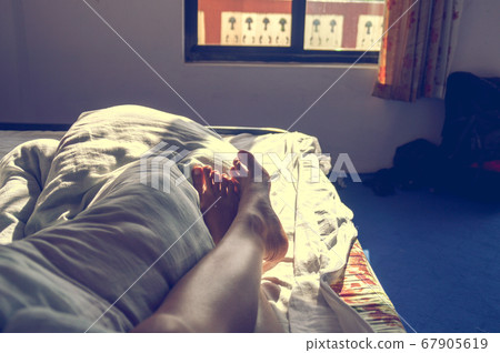 Conceptual photo showing the comfort and calm of staying in bed all day as the new normal lifestyle during home quarantine due to covid-19 pandemic 67905619