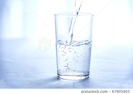 Water poured into the glass 67905803