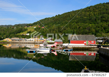 Norway Hardanger Fjord, watercraft Cessna U206F Station Air 6 reflected on the water surface like a mirror in the distance Norway Hardanger Fjord, watercraft Cessna U206F Station Air 6 reflected on the water surface like a mirror in the distance 67906267
