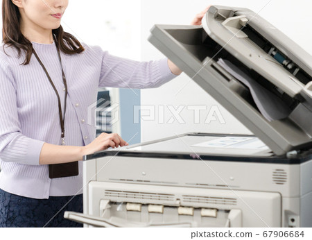 Up of female employees making a copy Up of female employees making a copy 67906684