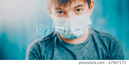 boy in medical face protection mask indoors on blue background boy in medical face protection mask indoors on blue background 67907173