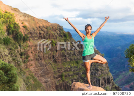 Yoga tree balance pose with open branch arms woman Yoga tree balance pose with open branch arms woman 67908720