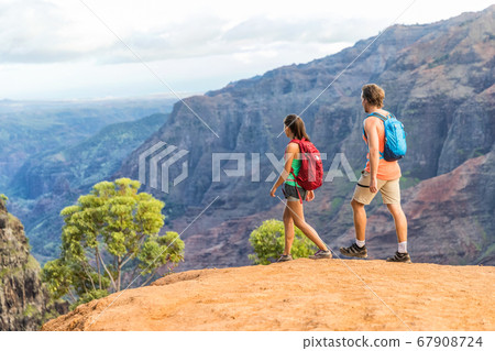 Hikers couple hiking in mountains canyon landscape 67908724